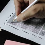 person writing on white paper