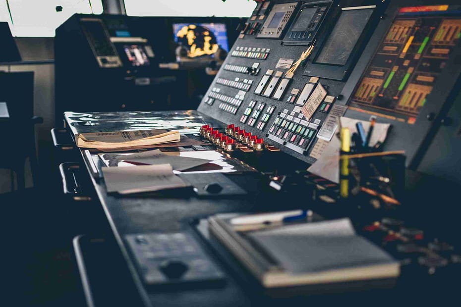 black flat screen tv turned on near black and gray audio component